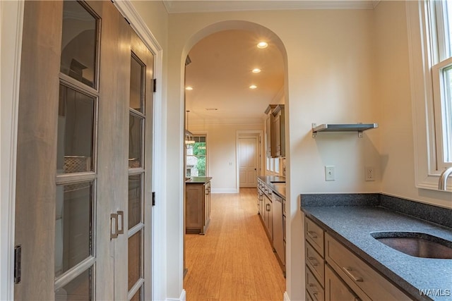 890 Founders St, Tuscaloosa, AL 35406 - kitchen featuring dark countertops, arched walkways, light wood-style flooring, ornamental molding, and recessed lighting
