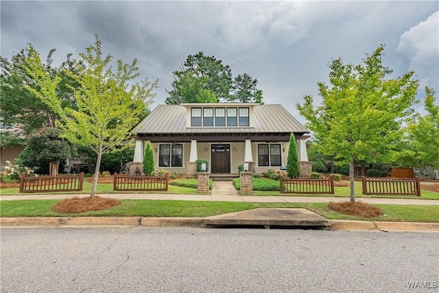 890 Founders St, Tuscaloosa, AL 35406 - craftsman-style home featuring a porch, a fenced front yard, a standing seam roof, and a metal roof