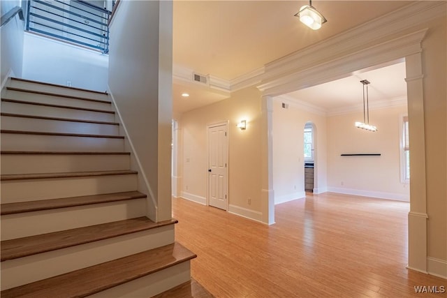 890 Founders St, Tuscaloosa, AL 35406 - stairs featuring ornamental molding, arched walkways, and wood finished floors