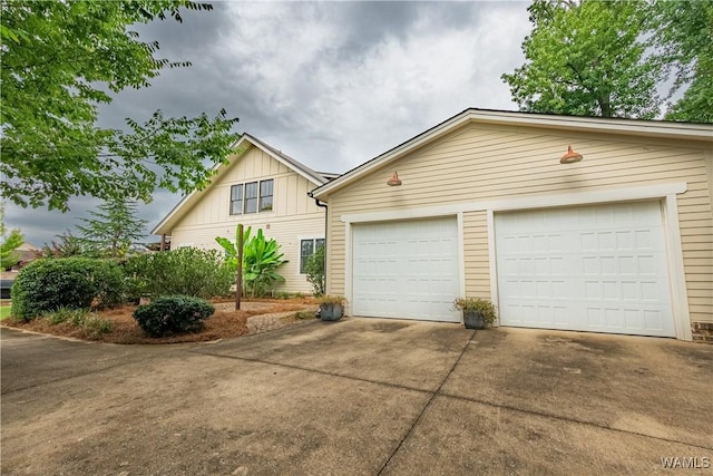 890 Founders St, Tuscaloosa, AL 35406 - view of front of property featuring board and batten siding, a garage, and driveway