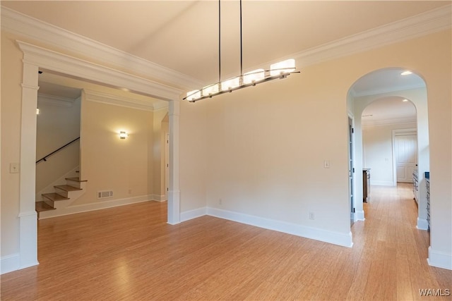 890 Founders St, Tuscaloosa, AL 35406 - spare room featuring light wood finished floors, ornamental molding, stairway, and arched walkways
