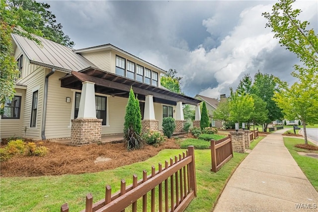 890 Founders St, Tuscaloosa, AL 35406 - view of side of home with a standing seam roof, a porch, a metal roof, a yard, and brick siding