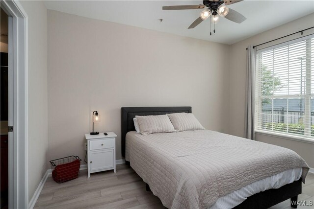 1901 5th Ave E Unit 2105, Tuscaloosa, AL 35401 - bedroom featuring light wood-style floors, baseboards, and a ceiling fan