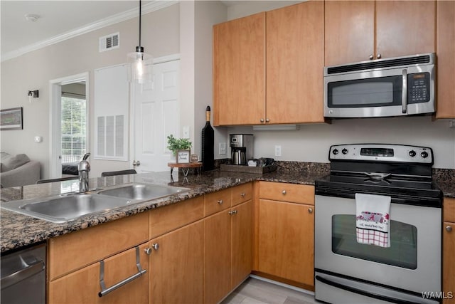 1901 5th Ave E Unit 2105, Tuscaloosa, AL 35401 - kitchen with appliances with stainless steel finishes, a sink, ornamental molding, pendant lighting, and dark stone counters