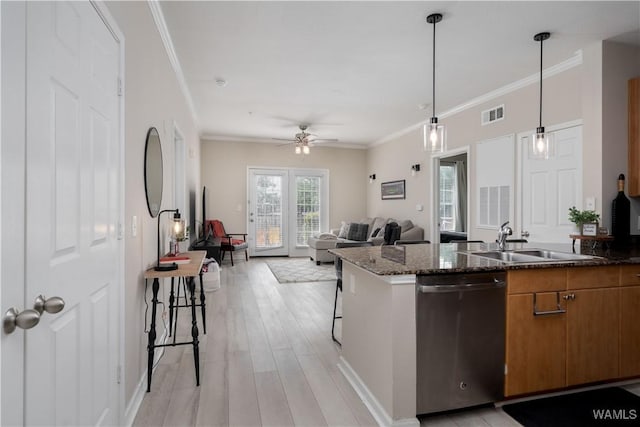 1901 5th Ave E Unit 2105, Tuscaloosa, AL 35401 - kitchen featuring stainless steel dishwasher, a sink, brown cabinetry, dark stone counters, and a ceiling fan