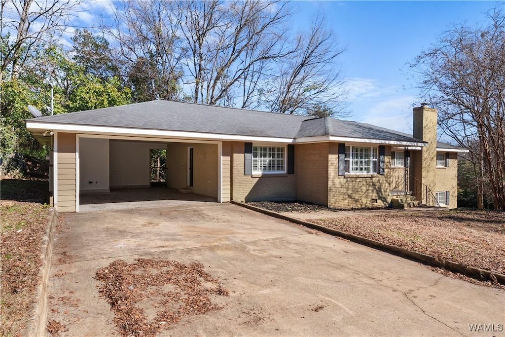 single story home featuring a carport