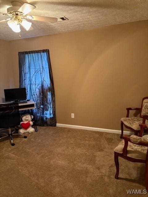 office with ceiling fan, carpet flooring, and a textured ceiling