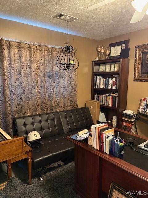 office with carpet and a textured ceiling