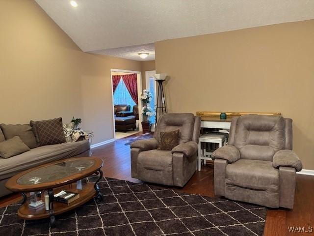 living room with vaulted ceiling and dark hardwood / wood-style floors