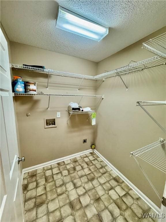 laundry area with washer hookup, a textured ceiling, and electric dryer hookup