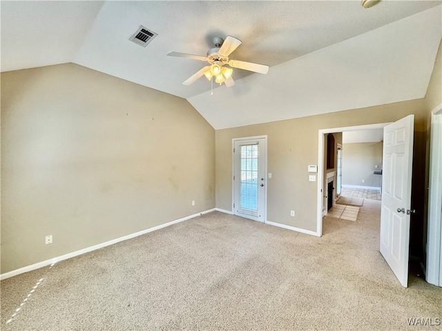 spare room with ceiling fan, light carpet, and lofted ceiling