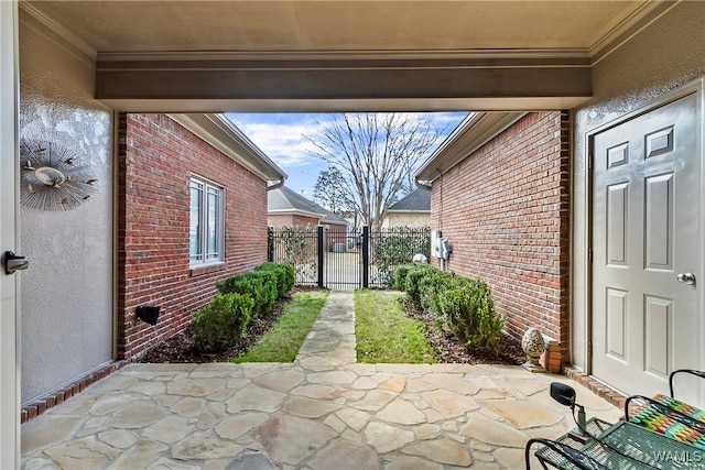 view of patio featuring a gate and fence