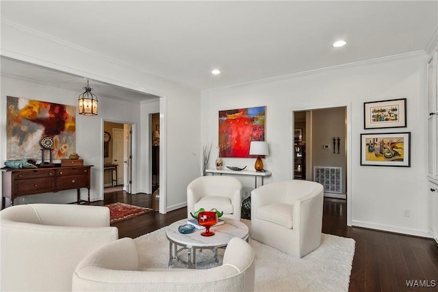 living area with dark wood finished floors, recessed lighting, visible vents, ornamental molding, and baseboards