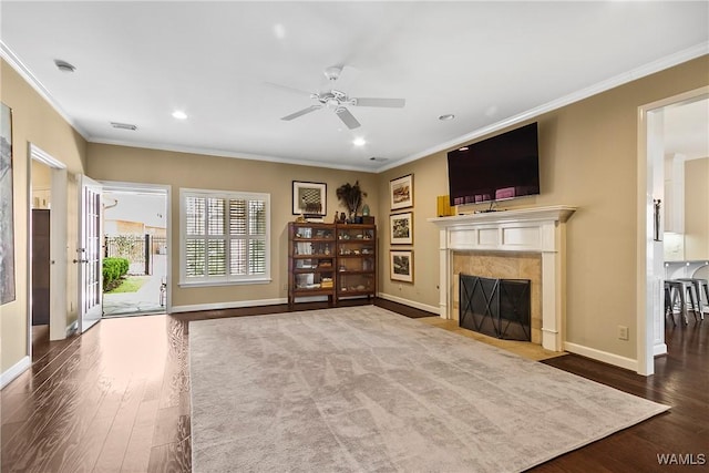 unfurnished living room with crown molding, a fireplace, and wood finished floors