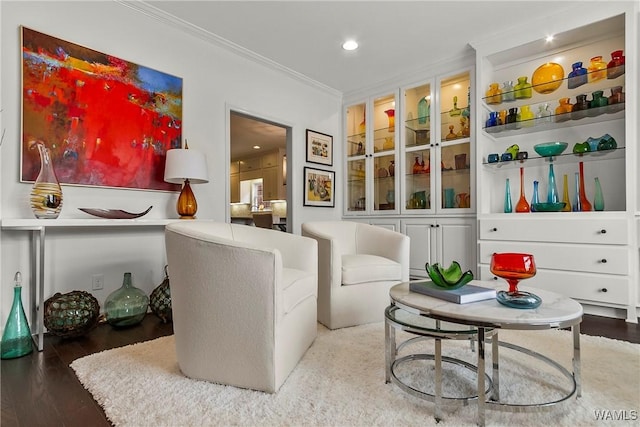 living area with recessed lighting, crown molding, and wood finished floors