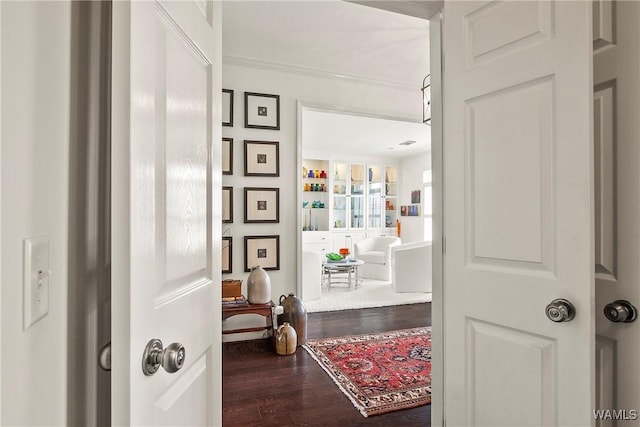 hall featuring ornamental molding and wood finished floors