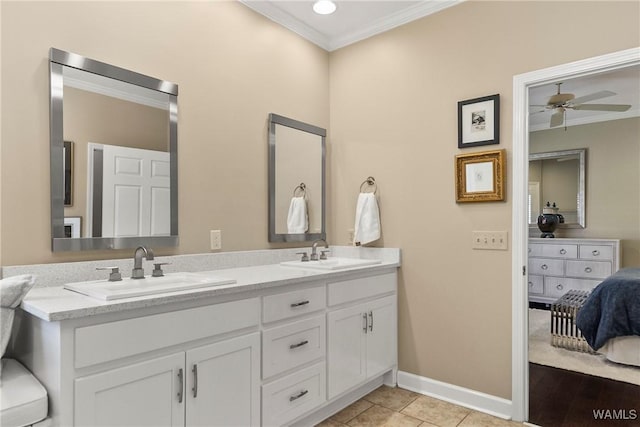 full bath featuring ornamental molding, a sink, baseboards, and double vanity