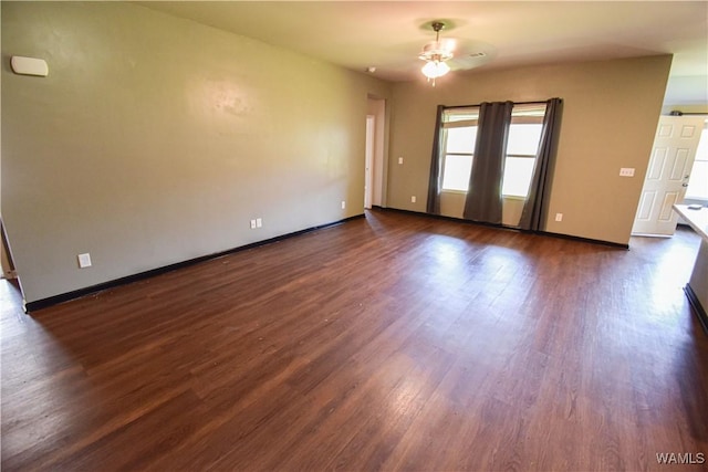 unfurnished room featuring ceiling fan and dark hardwood / wood-style flooring