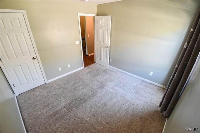 unfurnished bedroom featuring light carpet