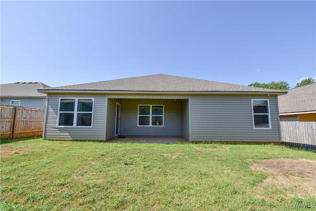 back of house featuring a lawn