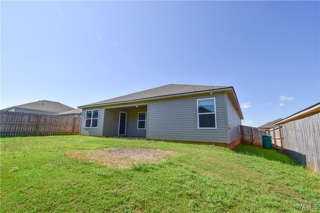 back of house featuring a lawn