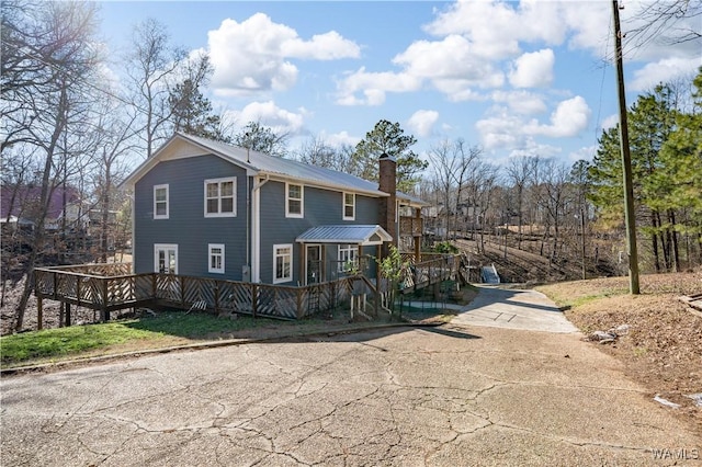 back of property with a wooden deck