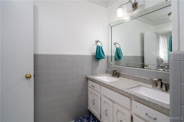 bathroom featuring tile walls, ornamental molding, and vanity