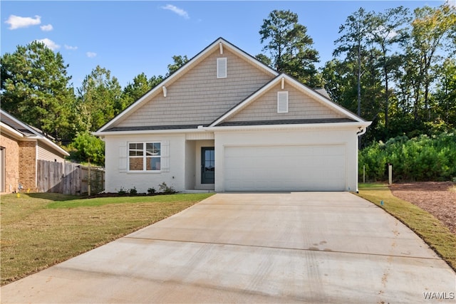 view of front of house with a front yard and a garage