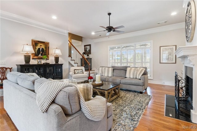 3610 Harbor Ridge Way, Tuscaloosa, AL 35406 - living area with ornamental molding, stairway, a ceiling fan, light wood finished floors, and a fireplace with flush hearth