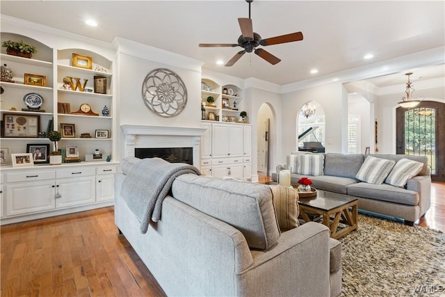 3610 Harbor Ridge Way, Tuscaloosa, AL 35406 - living room featuring arched walkways, light wood-style floors, ceiling fan, plenty of natural light, and ornamental molding