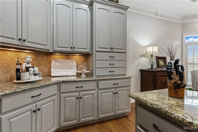 3610 Harbor Ridge Way, Tuscaloosa, AL 35406 - kitchen with decorative backsplash, gray cabinets, wood finished floors, crown molding, and light stone countertops