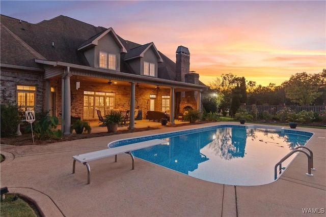 3610 Harbor Ridge Way, Tuscaloosa, AL 35406 - pool at dusk with a patio, a ceiling fan, fence, and a diving board