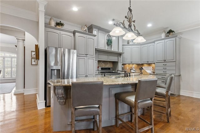 3610 Harbor Ridge Way, Tuscaloosa, AL 35406 - kitchen with baseboards, arched walkways, ornate columns, gray cabinets, and tasteful backsplash