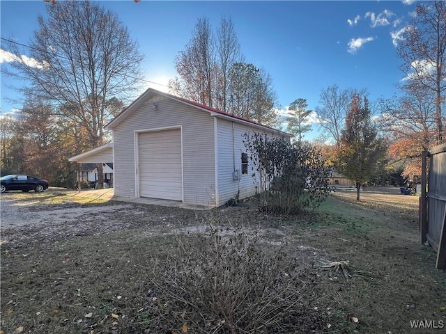 view of home's exterior with a garage and a carport