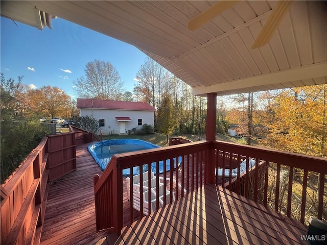 wooden terrace featuring a covered pool and ceiling fan