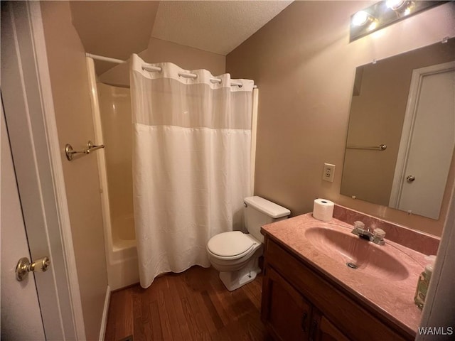 full bathroom featuring wood-type flooring, a textured ceiling, toilet, shower / tub combo with curtain, and vanity