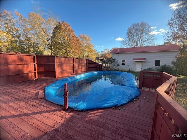 view of swimming pool with a wooden deck