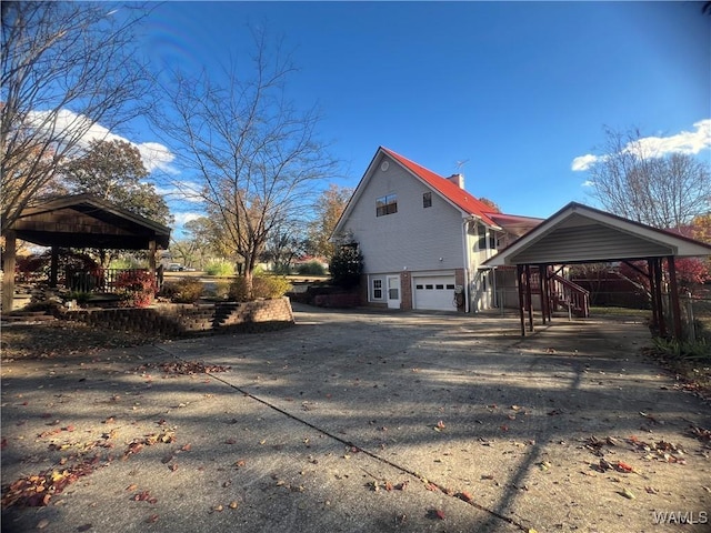 view of property exterior with a garage and a carport