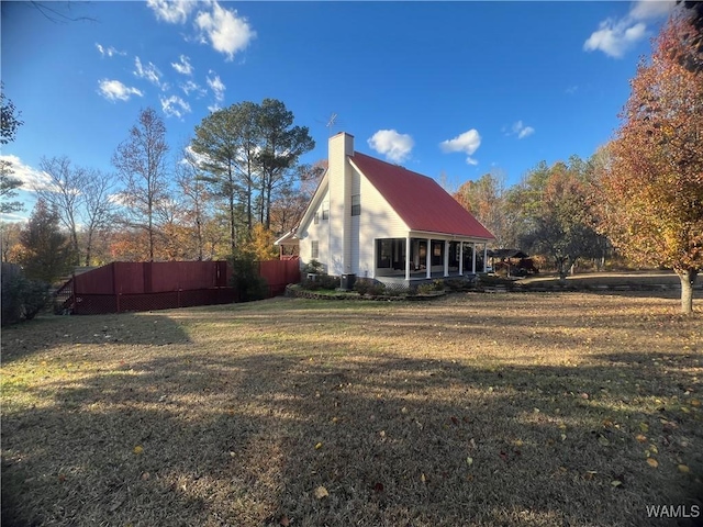 view of side of home featuring a lawn