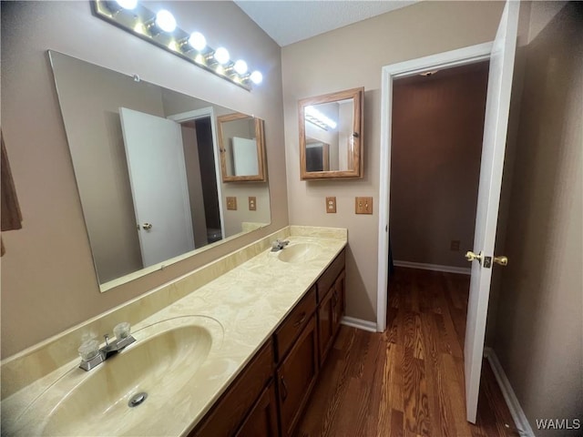 bathroom with vanity and hardwood / wood-style flooring