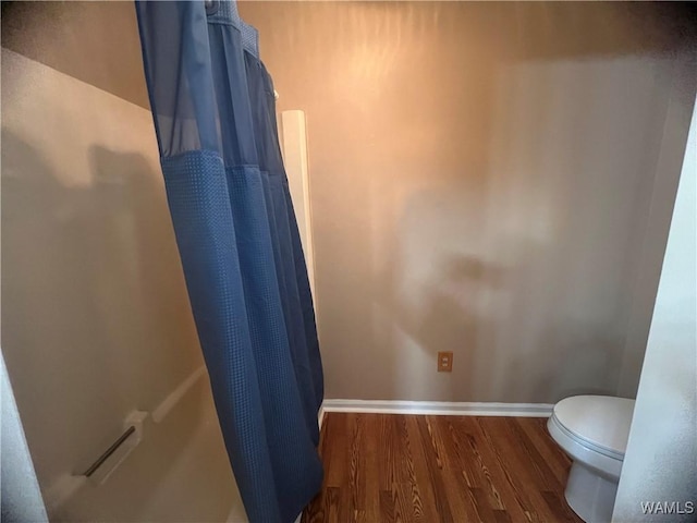 bathroom featuring hardwood / wood-style floors and toilet