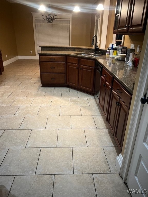 kitchen with black dishwasher, kitchen peninsula, sink, and hanging light fixtures