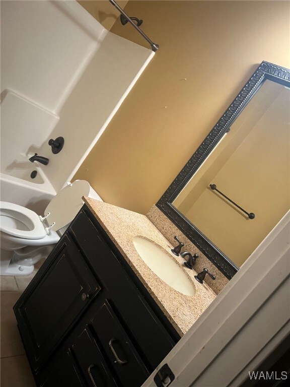 full bathroom featuring tile patterned floors, vanity, toilet, and shower / bath combination