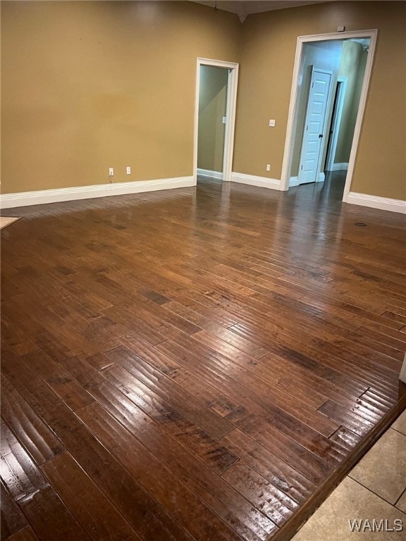 unfurnished room with dark hardwood / wood-style floors