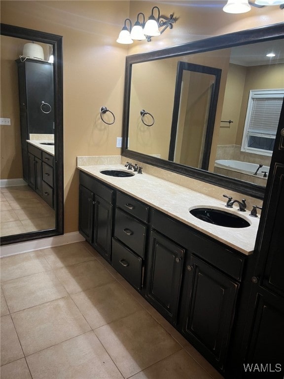 bathroom featuring a bathing tub, tile patterned flooring, and vanity