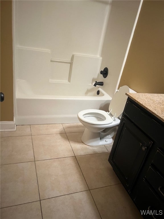 full bathroom featuring washtub / shower combination, tile patterned flooring, vanity, and toilet