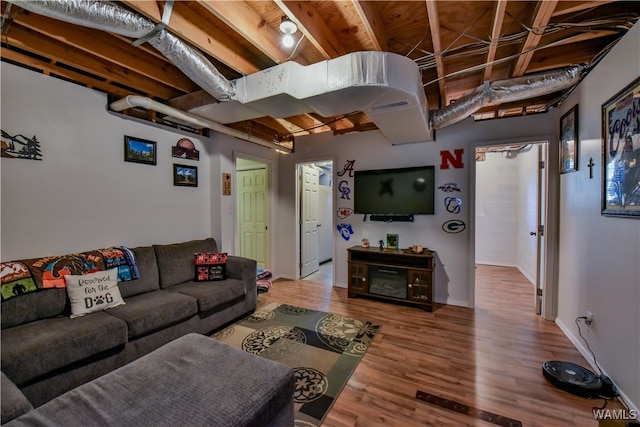 living room with beam ceiling and hardwood / wood-style floors