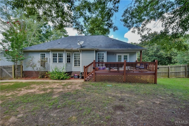 rear view of property with a yard and a deck