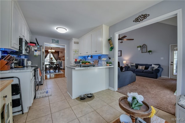 kitchen with white cabinets, ceiling fan, and light tile patterned flooring