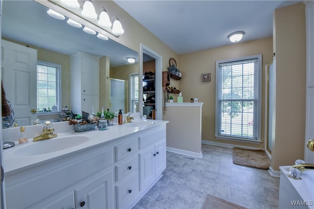 bathroom featuring vanity and an enclosed shower